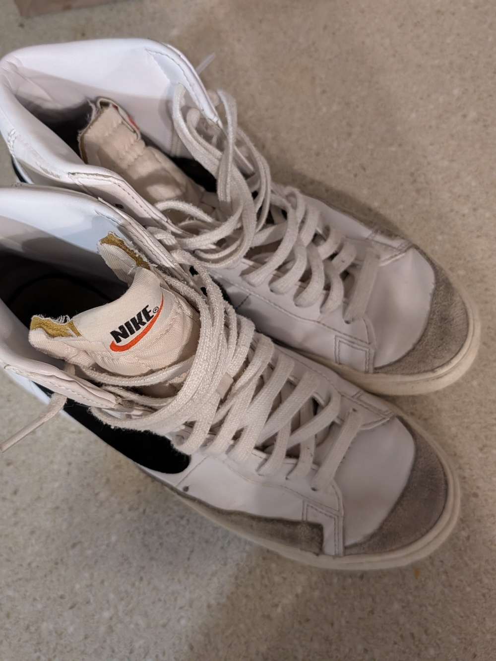 Nike White High-Top Sneakers with Black Swoosh
